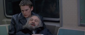 Movie still from “Great Expectations” (1998), directed by Alfonso Cuarón – A man sleeping on a seat next to another man on a bus; Close Up shot, Low angle