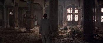 Movie still from “Great Expectations” (1998), directed by Alfonso Cuarón – A man in a suit walking through a room; Wide shot, Low angle