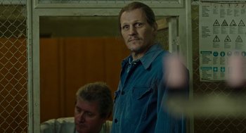 Movie still from “Great Freedom” (2021), directed by Sebastian Meise – A man standing next to another man in a room; Medium shot, Over the shoulder angle