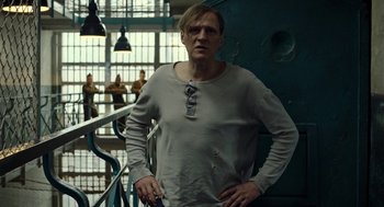 Movie still from “Great Freedom” (2021), directed by Sebastian Meise – A man standing in a room next to a railing; Medium shot, Low angle