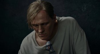 Movie still from “Great Freedom” (2021), directed by Sebastian Meise – A person wearing a shirt and a neck tie; Close Up shot, Low angle