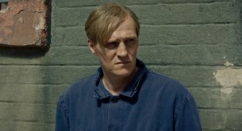 Movie still from “Great Freedom” (2021), directed by Sebastian Meise – A person wearing a blue jacket; Close Up shot, Low angle