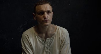 Movie still from “Great Freedom” (2021), directed by Sebastian Meise – A man in a white shirt is posing for a picture; Close Up shot, High angle