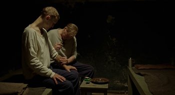 Movie still from “Great Freedom” (2021), directed by Sebastian Meise – A couple of men sitting next to each other on a bench; Medium shot, High angle