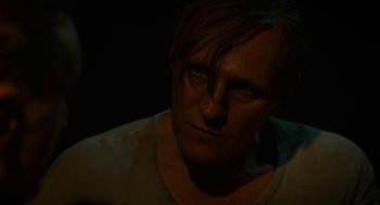 Movie still from “Great Freedom” (2021), directed by Sebastian Meise – A person with long dark hair; Close Up shot, Over the shoulder angle