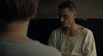 Movie still from “Great Freedom” (2021), directed by Sebastian Meise – A man looking into a mirror while standing next to another man; Close Up shot, Over the shoulder angle