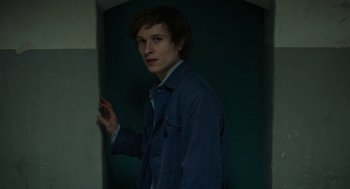 Movie still from “Great Freedom” (2021), directed by Sebastian Meise – A young man standing in front of a wall in a room; Close Up shot, High angle