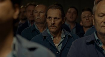 Movie still from “Great Freedom” (2021), directed by Sebastian Meise – A group of men standing next to each other in a room; Close Up shot, Over the shoulder angle