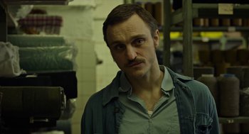 Movie still from “Great Freedom” (2021), directed by Sebastian Meise – A person wearing a shirt; Close Up shot, Low angle