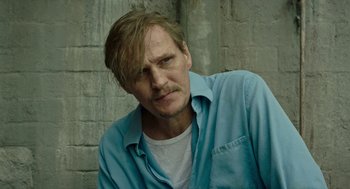 Movie still from “Great Freedom” (2021), directed by Sebastian Meise – A person wearing a blue shirt; Close Up shot, High angle