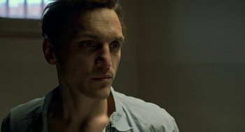 Movie still from “Great Freedom” (2021), directed by Sebastian Meise – A person wearing a blue shirt; Close Up shot, Low angle