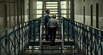 Movie still from “Great Freedom” (2021), directed by Sebastian Meise – Two men walking up a set of stairs; Wide shot, Low angle