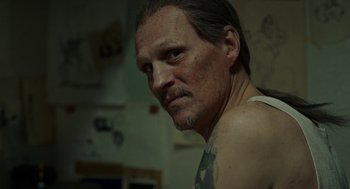 Movie still from “Great Freedom” (2021), directed by Sebastian Meise – A person with a tattoo on his arm; Close Up shot, Over the shoulder angle