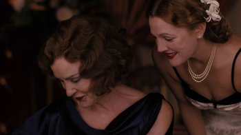 Movie still from “Grey Gardens” (2009), directed by Michael Sucsy – Two women are laughing together at a party; Close Up shot, Over the shoulder angle
