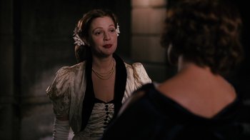 Movie still from “Grey Gardens” (2009), directed by Michael Sucsy – A woman in a white dress talking to another woman; Medium shot, Over the shoulder angle