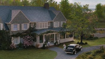 Movie still from “Grey Gardens” (2009), directed by Michael Sucsy – An old car parked in front of a large house; Extreme Wide shot, High angle