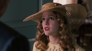 Movie still from “Grey Gardens” (2009), directed by Michael Sucsy – A woman wearing a straw hat and a yellow dress; Close Up shot, Over the shoulder angle