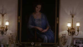 Movie still from “Grey Gardens” (2009), directed by Michael Sucsy – A painting of a woman sitting in a chair in front of a mirror; Medium shot, Over the shoulder angle