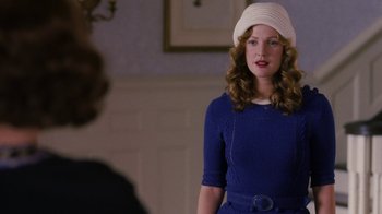 Movie still from “Grey Gardens” (2009), directed by Michael Sucsy – A woman wearing a white hat standing in front of another woman; Medium shot, Over the shoulder angle