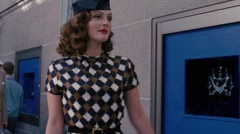 Movie still from “Grey Gardens” (2009), directed by Michael Sucsy – A woman wearing a hat and a checkered dress; Medium shot, Low angle