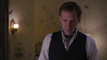 Movie still from “Grey Gardens” (2009), directed by Michael Sucsy – A person wearing a suit and tie; Close Up shot, Over the shoulder angle