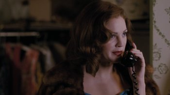 Movie still from “Grey Gardens” (2009), directed by Michael Sucsy – A woman talking on a phone while wearing a fur coat; Close Up shot, Over the shoulder angle