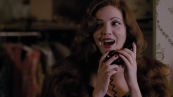 Movie still from “Grey Gardens” (2009), directed by Michael Sucsy – A woman holding a cell phone up to her ear; Close Up shot, Over the shoulder angle