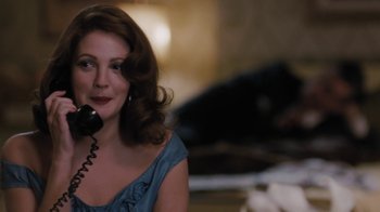 Movie still from “Grey Gardens” (2009), directed by Michael Sucsy – A woman is talking on a phone while sitting down; Close Up shot, Over the shoulder angle