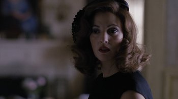 Movie still from “Grey Gardens” (2009), directed by Michael Sucsy – A woman in a black dress and a black hat; Close Up shot, Over the shoulder angle