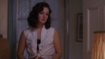 Movie still from “Grey Gardens” (2009), directed by Michael Sucsy – A woman in a white shirt is standing in front of a window; Medium shot, Over the shoulder angle