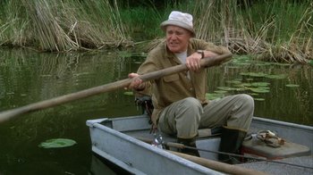 Movie still from “Grumpier Old Men” (1995), directed by Howard Deutch – An older man rowing a boat in the water; Medium shot, High angle
