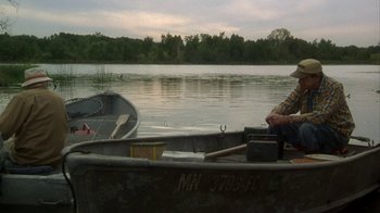 Movie still from “Grumpier Old Men” (1995), directed by Howard Deutch – A man sitting in a boat on a lake; Wide shot, High angle