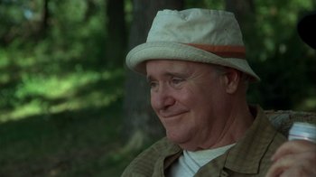 Movie still from “Grumpier Old Men” (1995), directed by Howard Deutch – An older man wearing a hat and smiling for the camera; Close Up shot, Low angle