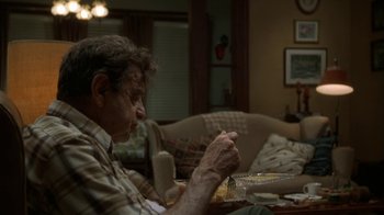 Movie still from “Grumpier Old Men” (1995), directed by Howard Deutch – An older man sitting at a table eating food; Medium shot, Over the shoulder angle