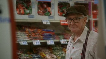 Movie still from “Grumpier Old Men” (1995), directed by Howard Deutch – An older man in a hat and glasses in a store; Medium shot, Over the shoulder angle