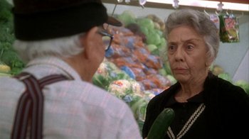 Movie still from “Grumpier Old Men” (1995), directed by Howard Deutch – An older woman and an older man in front of a display of vegetables; Close Up shot, Over the shoulder angle