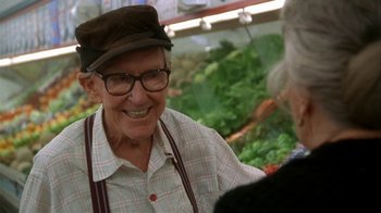 Movie still from “Grumpier Old Men” (1995), directed by Howard Deutch – An older man wearing glasses and a hat talking to an older woman; Medium shot, Over the shoulder angle