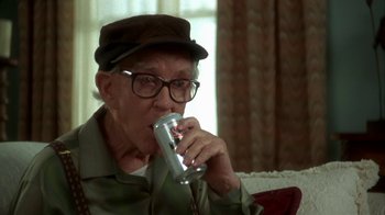 Movie still from “Grumpier Old Men” (1995), directed by Howard Deutch – An older man drinking a can of soda; Close Up shot, High angle