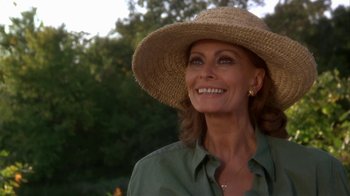 Movie still from “Grumpier Old Men” (1995), directed by Howard Deutch – A woman wearing a straw hat smiling for the camera; Close Up shot, Low angle
