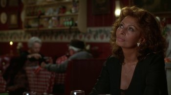 Movie still from “Grumpier Old Men” (1995), directed by Howard Deutch – A woman sitting at a table in a restaurant; Close Up shot, Over the shoulder angle