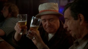 Movie still from “Grumpier Old Men” (1995), directed by Howard Deutch – A man in a hat holding a glass of beer; Close Up shot, Low angle