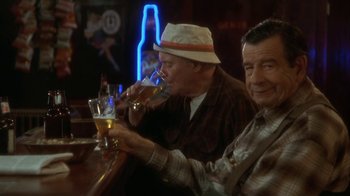 Movie still from “Grumpier Old Men” (1995), directed by Howard Deutch – Two men sitting at a bar drinking beer; Medium shot, High angle