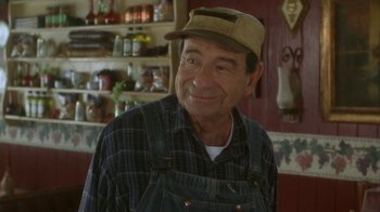 Movie still from “Grumpier Old Men” (1995), directed by Howard Deutch – An older man wearing a hat and overalls in a store; Medium shot, Over the shoulder angle