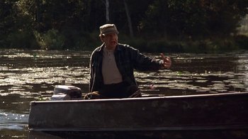 Movie still from “Grumpier Old Men” (1995), directed by Howard Deutch – An older man in a boat on a river; Medium shot, Over the shoulder angle