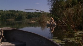 Movie still from “Grumpier Old Men” (1995), directed by Howard Deutch – A person in a boat on a river; Wide shot, High angle