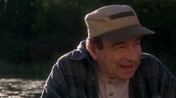 Movie still from “Grumpier Old Men” (1995), directed by Howard Deutch – An older man wearing a hat and a plaid shirt; Close Up shot, Over the shoulder angle