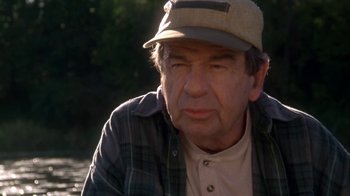 Movie still from “Grumpier Old Men” (1995), directed by Howard Deutch – An older man wearing a hat and a plaid shirt; Close Up shot, Over the shoulder angle