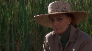 Movie still from “Grumpier Old Men” (1995), directed by Howard Deutch – A woman wearing a straw hat in front of tall grass; Close Up shot, Over the shoulder angle