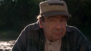 Movie still from “Grumpier Old Men” (1995), directed by Howard Deutch – An older man wearing a hat and a plaid shirt; Close Up shot, Over the shoulder angle