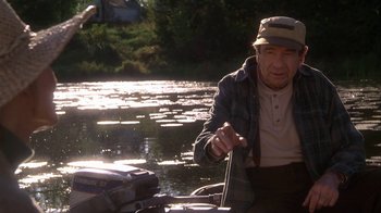 Movie still from “Grumpier Old Men” (1995), directed by Howard Deutch – An old man is fishing in a river; Medium shot, Over the shoulder angle